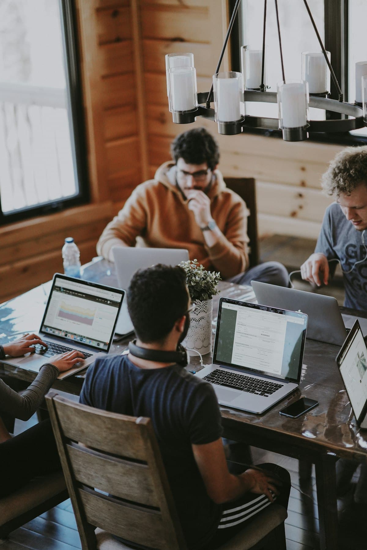 Professionals working together around a table with laptops